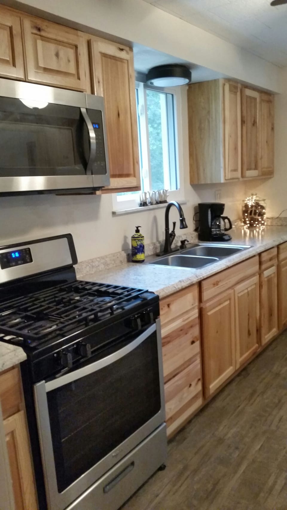 There is a gas range/oven, a microwave, full refrigerator and small appliances