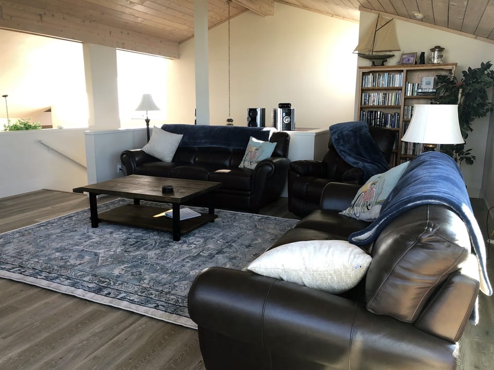 Living Room area looking down towards first floor.  Vaulted ceilings and numerous sky lights give lots of natural lighting.