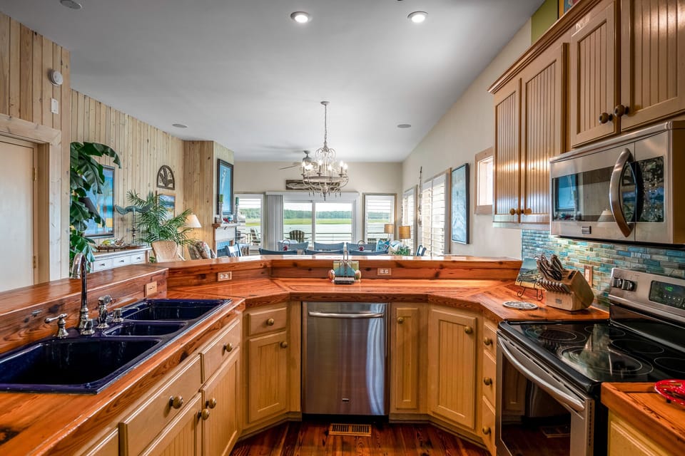 Kitchen looking out over dining and living rooms out to the inlet