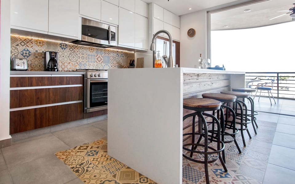 Modern Kitchen with quartz waterfall island that is open to the living space.