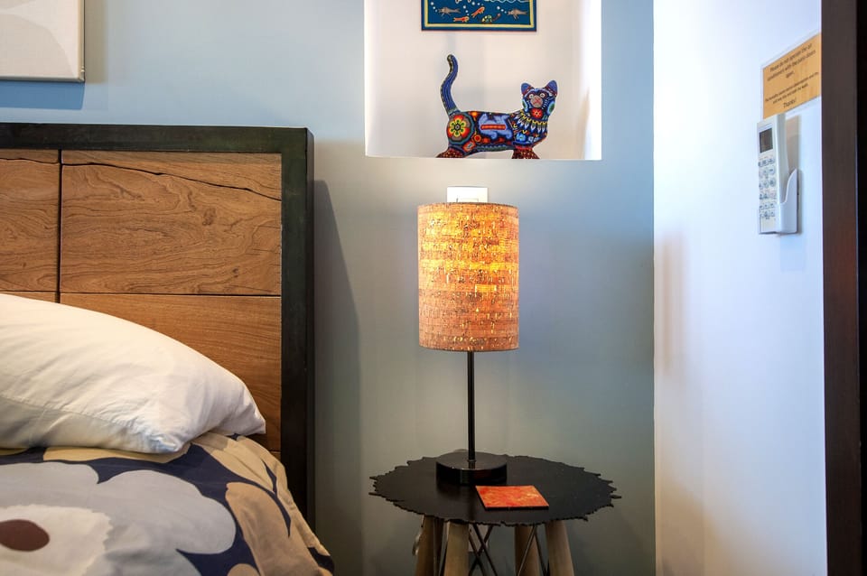 Cork lamp with locally crafted Mexican artwork and reclaimed furniture.