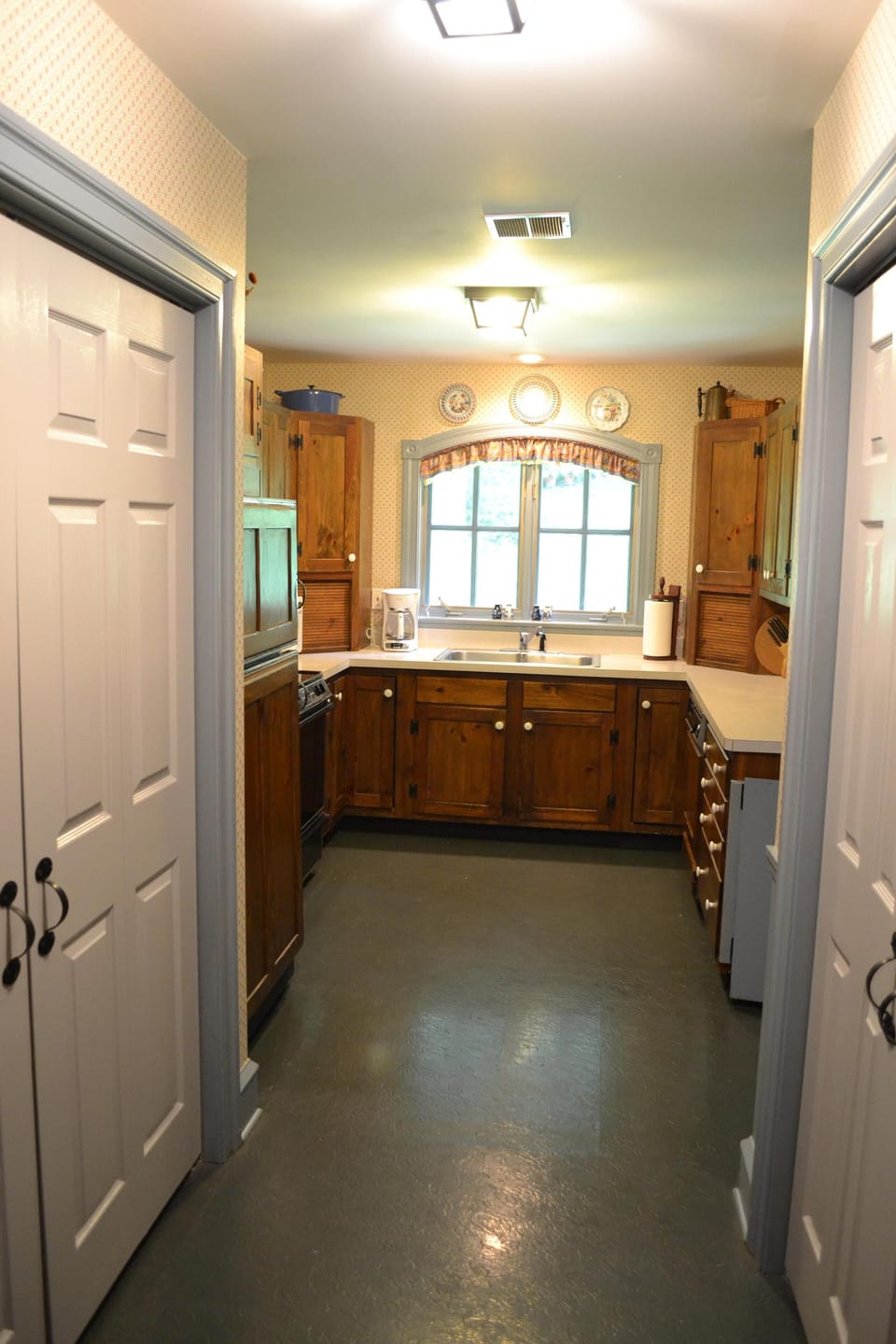 Kitchen with laundry in closet to the left and pantry in closets to right. 