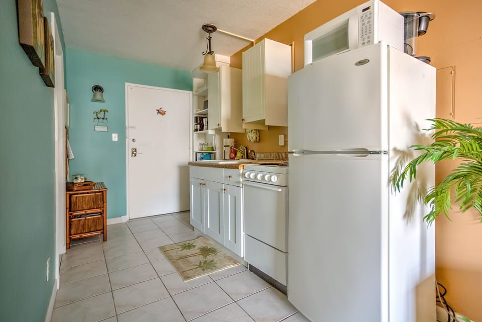 Full size refrigerator also an apartment sized stove and all the cooking tools 