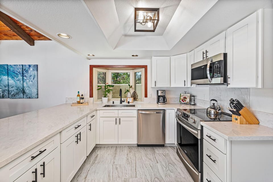 Freshly updated kitchen with quartz countertops, stainless steel appliances, and clean modern finishes.