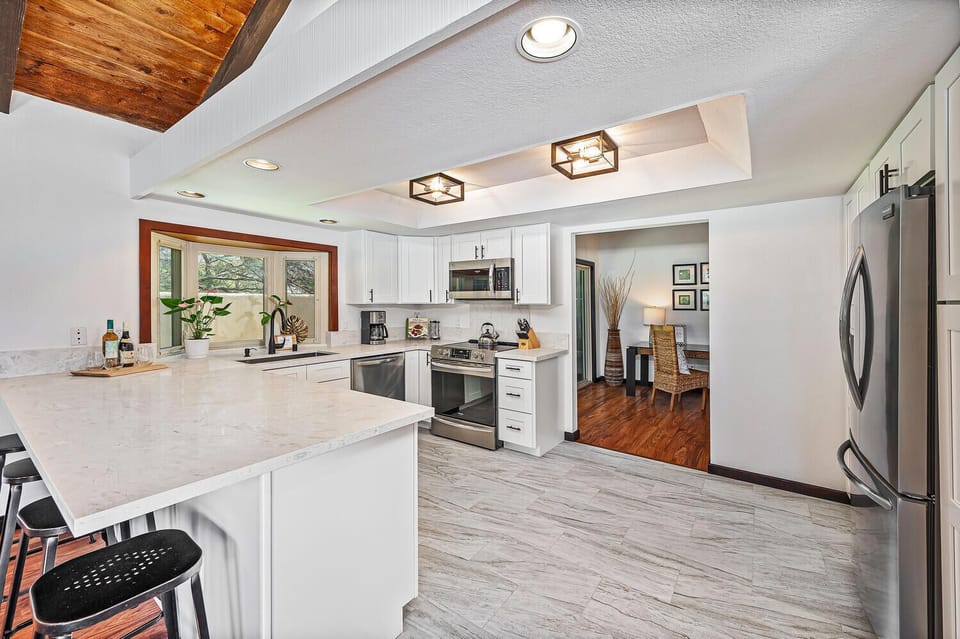 Bright, chef-ready kitchen with quartz countertops and modern appliances.