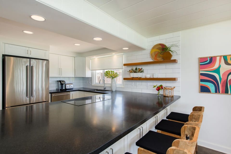 Prepare fresh island meals in this sleek, updated kitchen with ocean views, ample counter space, and bar seating for casual breakfasts.