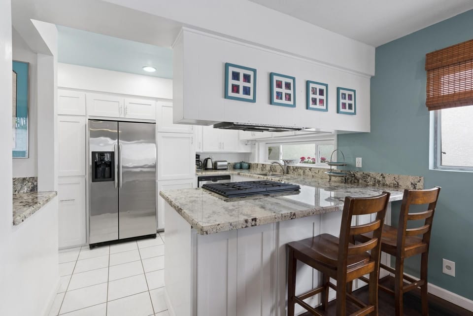 The breakfast bar seating makes meal time a social affair.
                