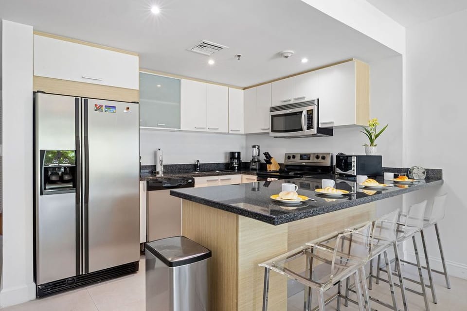 Your sleek, modern kitchen comes fully equipped with stainless steel appliances, granite countertops, and a breakfast bar where you can sip coffee and plan your day.