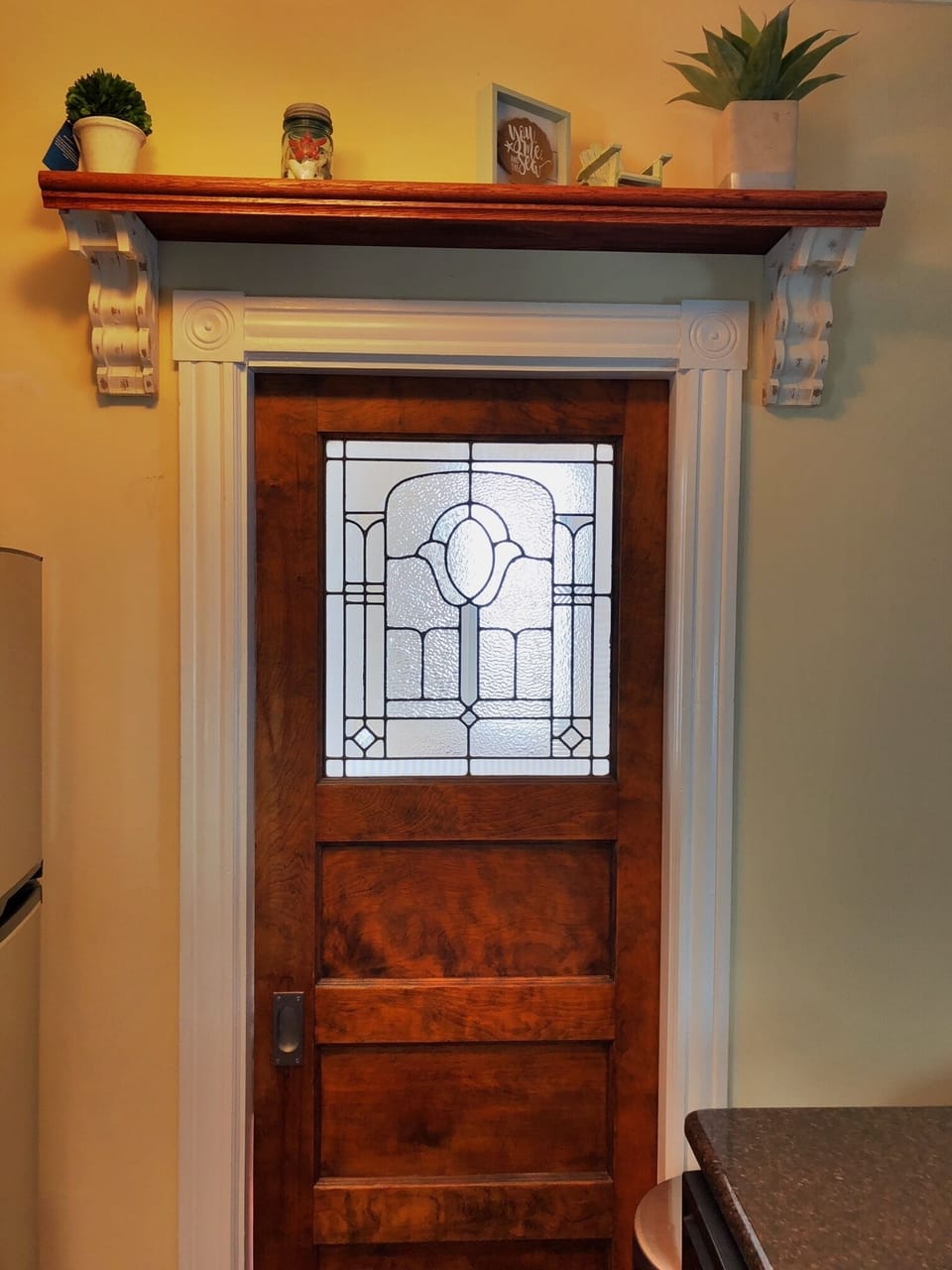Antique leaded door leading to sun room/second bedroom with sleeper sofa
