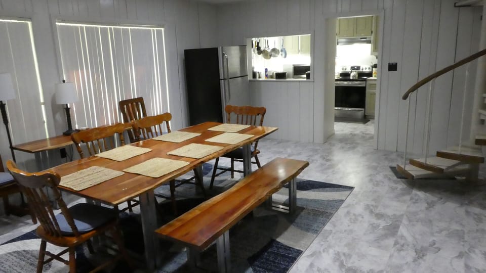 Dining room (with extra fridge) looking into kitchen.