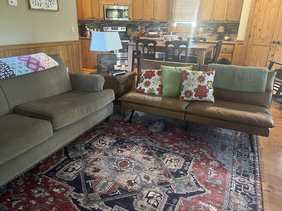 Open den with seating for 8 and open to kitchen and outside deck