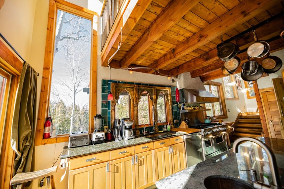 Large window framing the Aspens in the kitchen