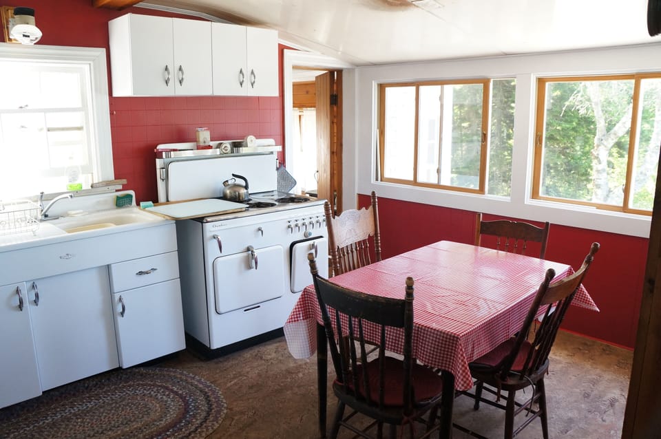 The kitchen boasts an ocean view and vintage gas range.