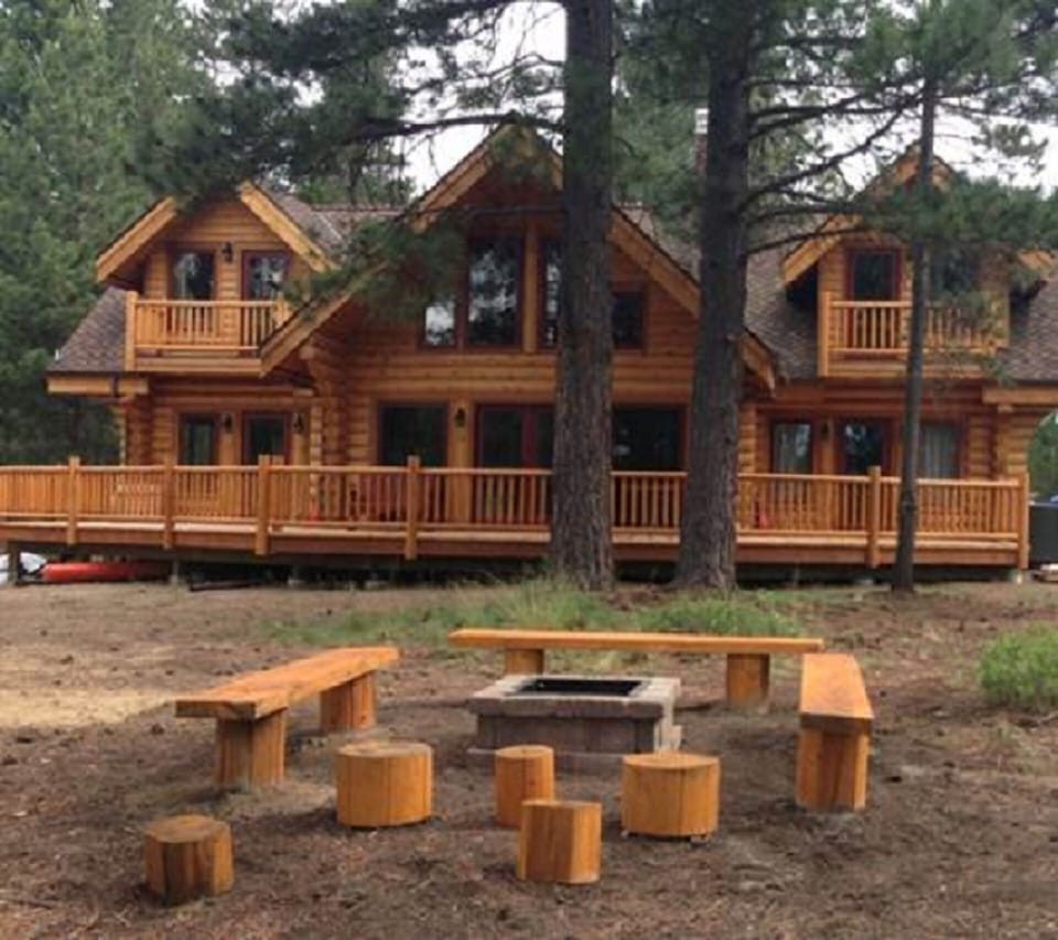 View of the river side of the cabin and fire pit.
