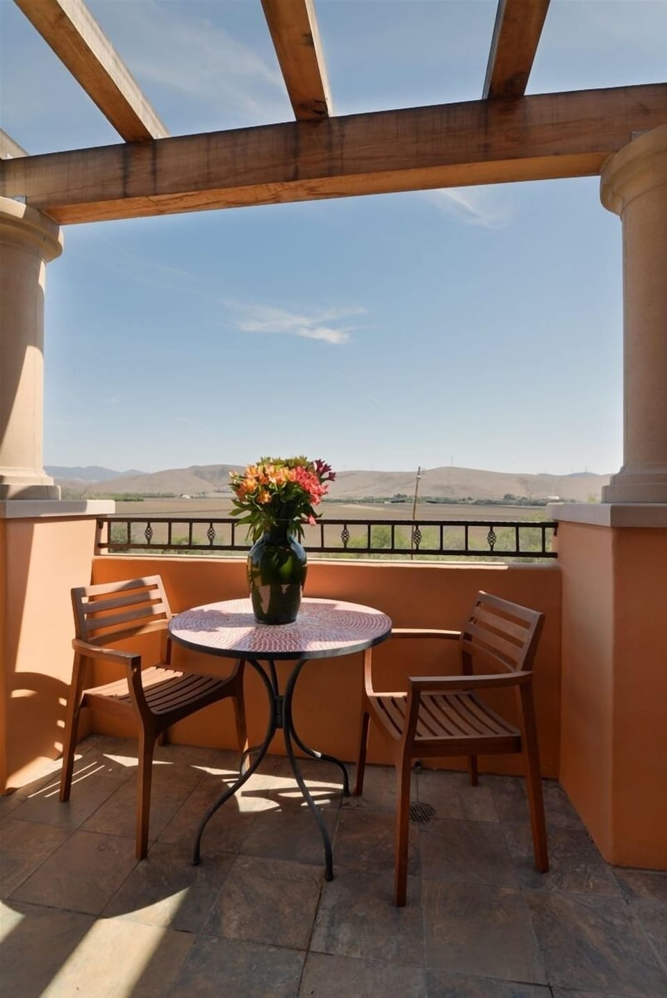 The balcony has nice views of the surrounding hillside.