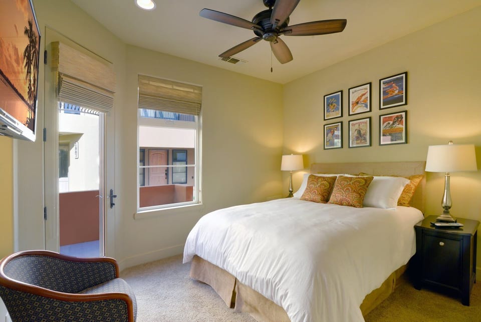 The second bedroom has a queen bed, TV and access to the back patio.
