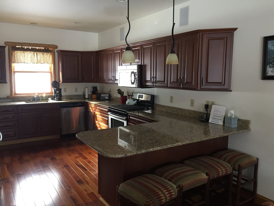 Full kitchen with refridgerator, microwave, dishwasher, sink, freezer, and stove
