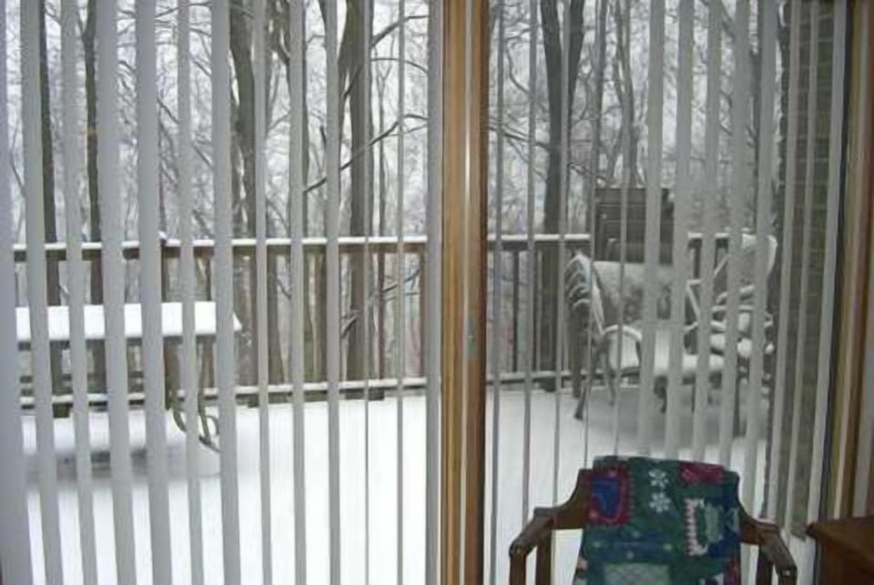 Large Deck and large sliding glass doors looking out to winter snows.