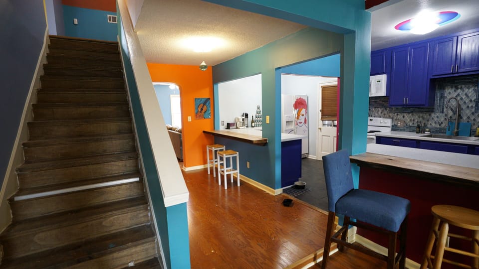 Stairs to second level, kitchen and bar tops