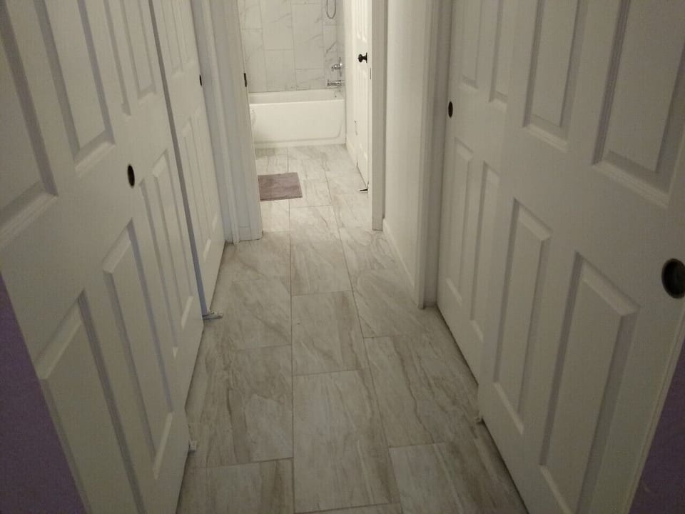 Hallway bath interior walkway to 2nd bedroom and closet space.