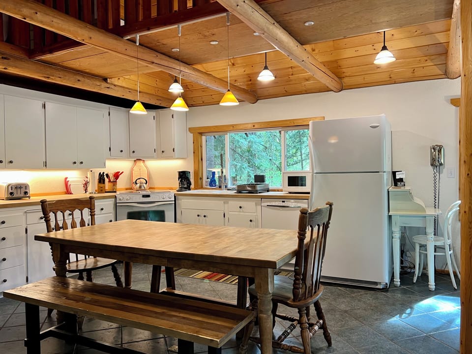 Full kitchen well stocked for cooking.