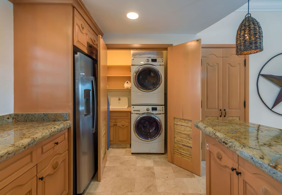 Stacked washer/dryer just off kitchen