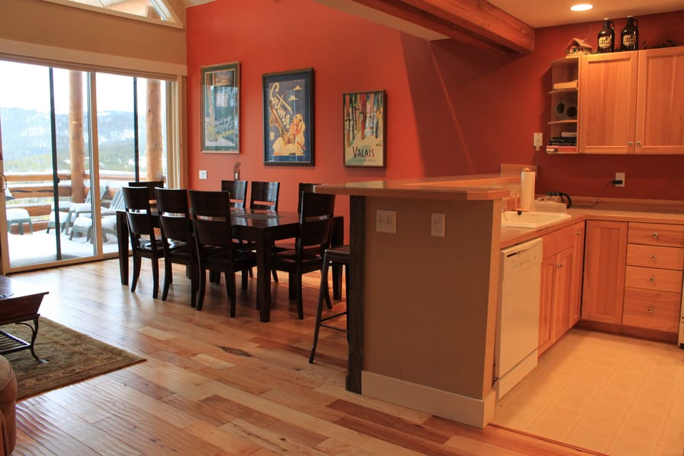 Deck off the main living area includes a gas grill and seating 
