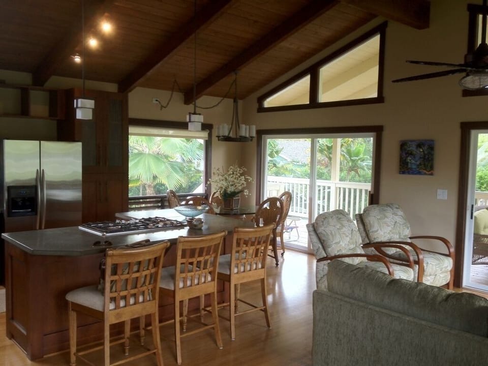 Great room with dining table and open bar.