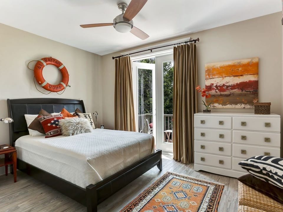 Tastefully decorated queen bedroom with balcony overlooking the courtyard
