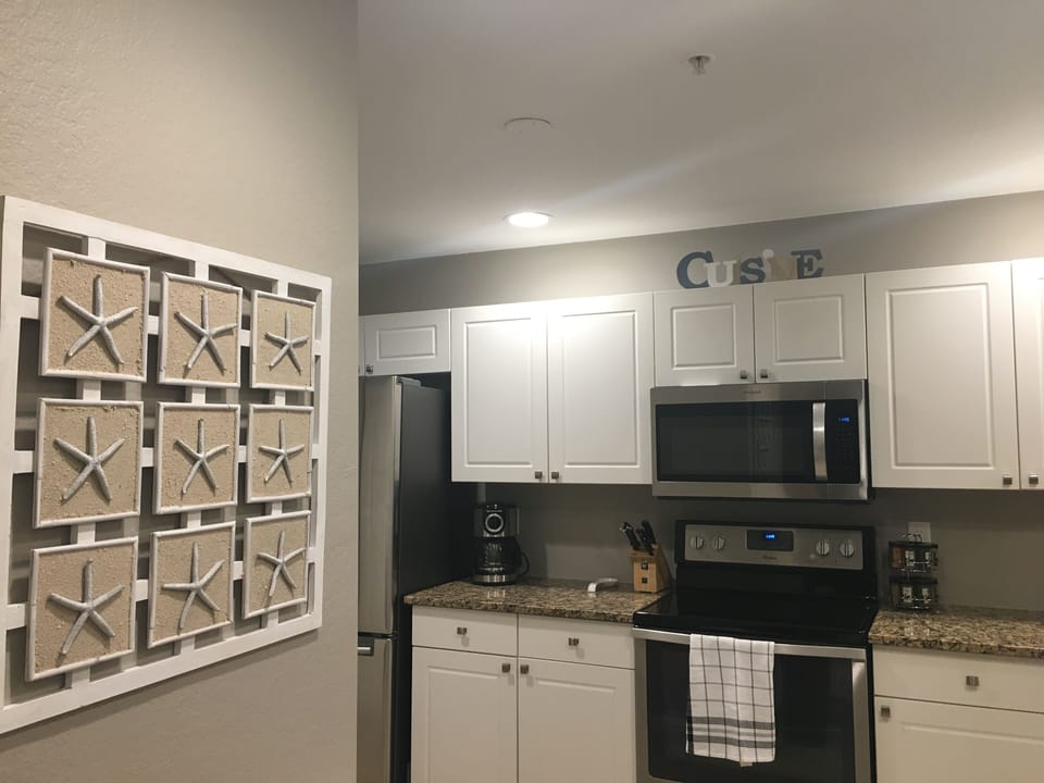 Large functional kitchen with granite countertops. 
