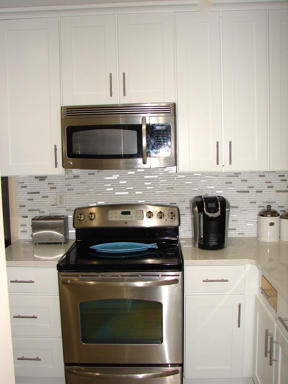 All new cabinets, stainless appliances, quartz countertops and wood floors. 