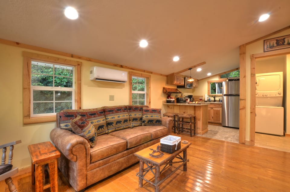 Open living area connects cozy seating and full kitchen.