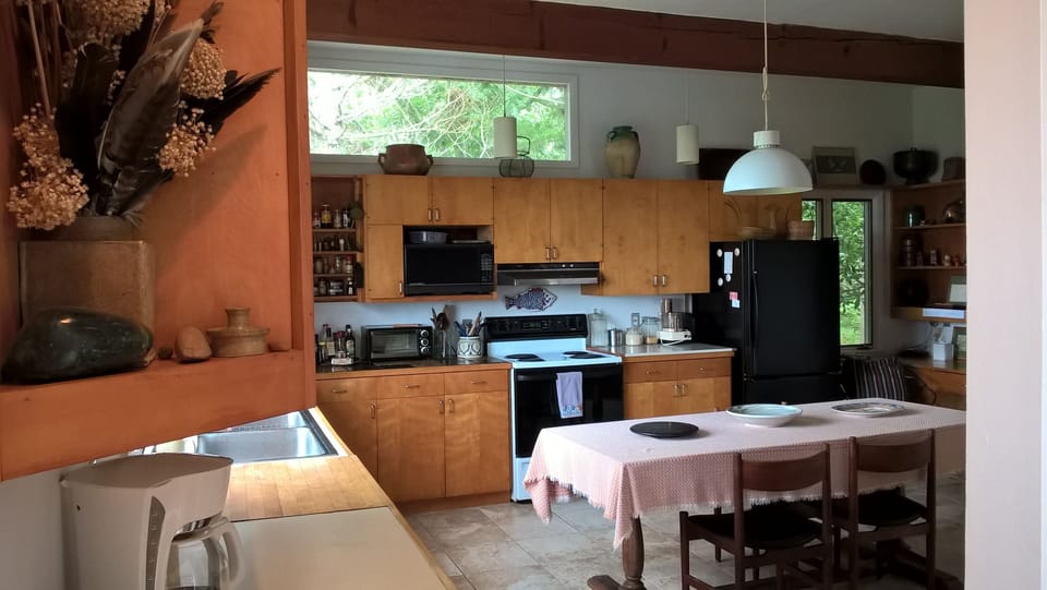 Kitchen has a table in addition to the larger one in dining area of living room.