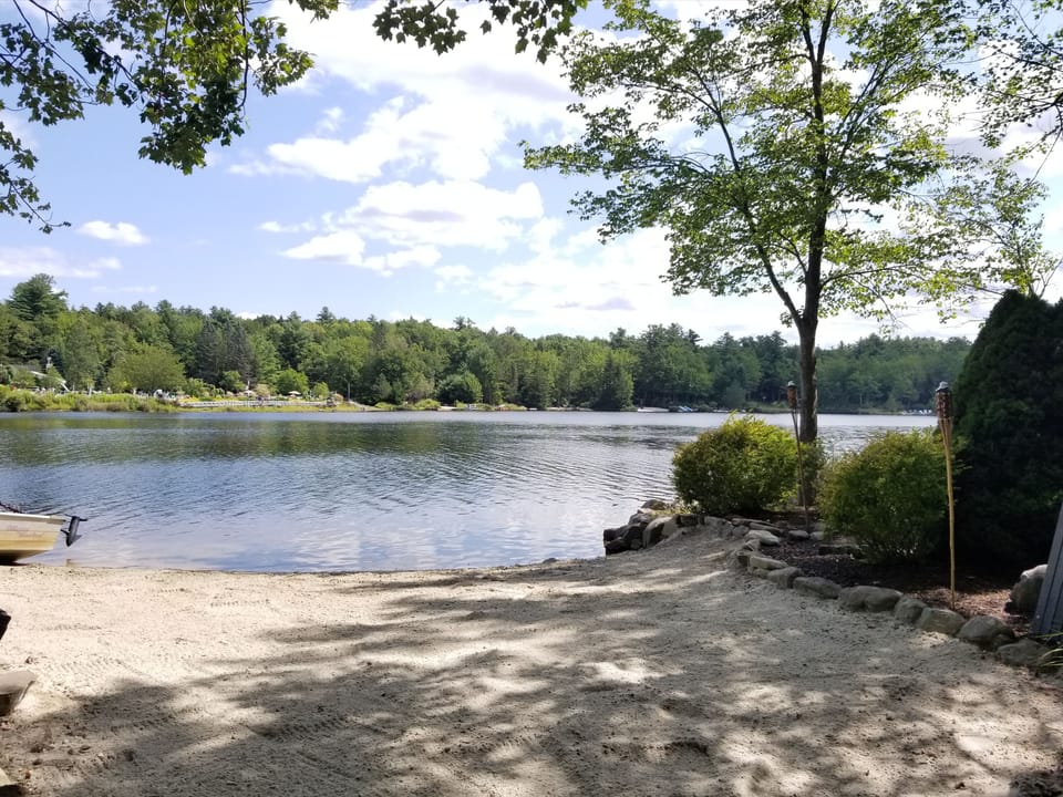 Private beach with beach chairs, 2 kayaks, rowboat, and canoe for your use. 