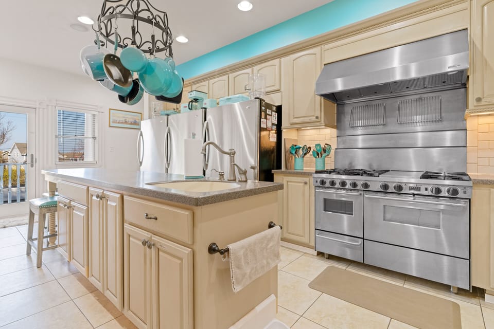 Commercial range with 6 burners, grill, 2 ovens, 3 refridgerators.