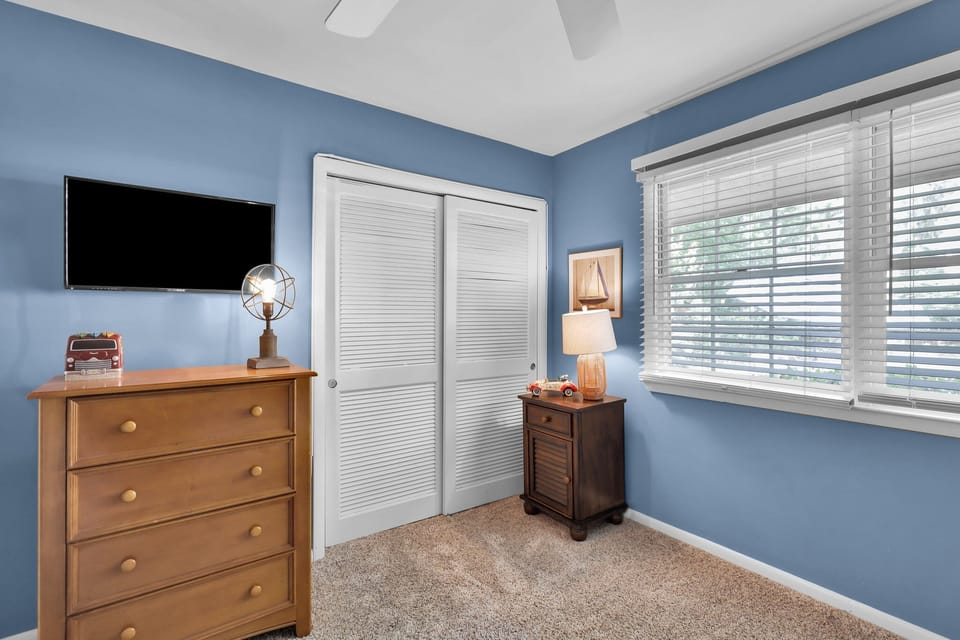 Bedroom 2 - twin over twin bunk beds with an additional twin bed with a flat screen tv.