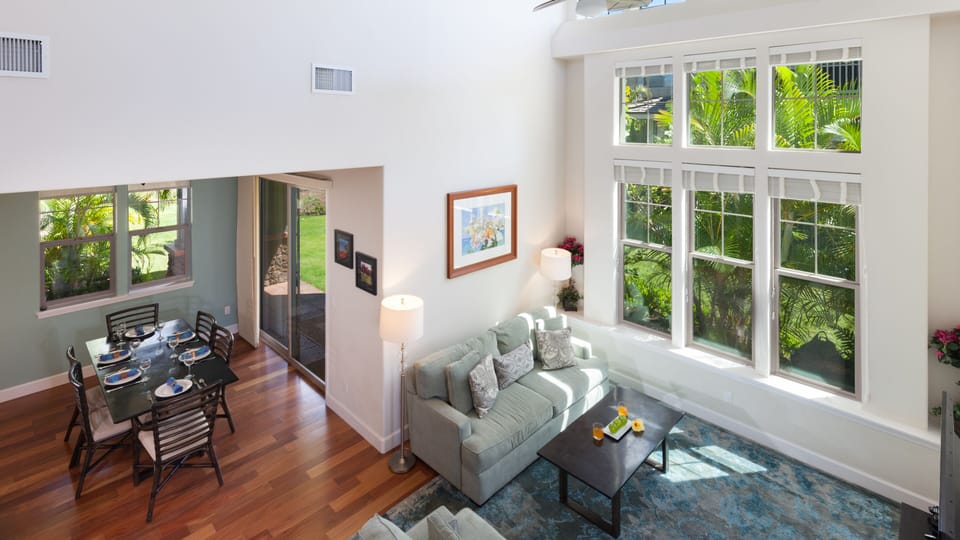 The bright and airy living room boasts 20" ceilings