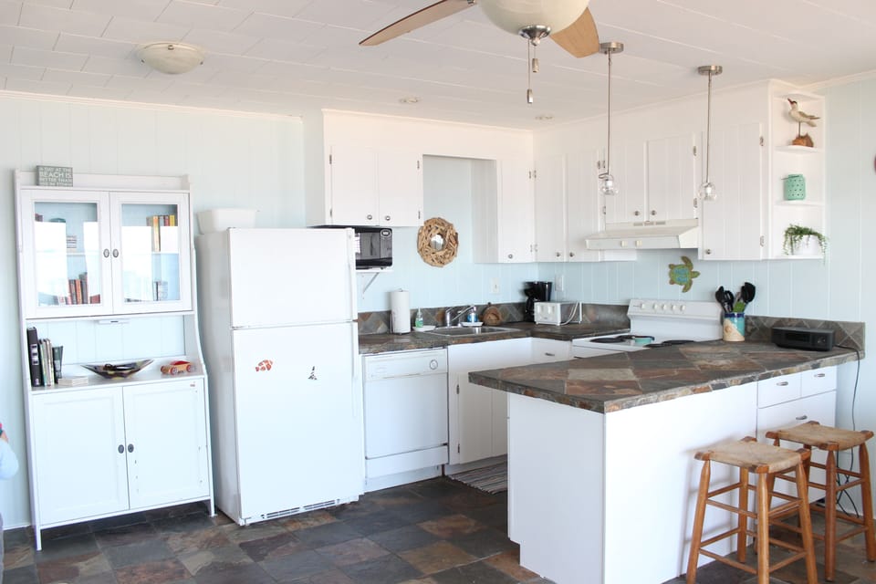 Kitchen area w/ fridge, dishwasher, stove, microwave, toaster, coffee maker