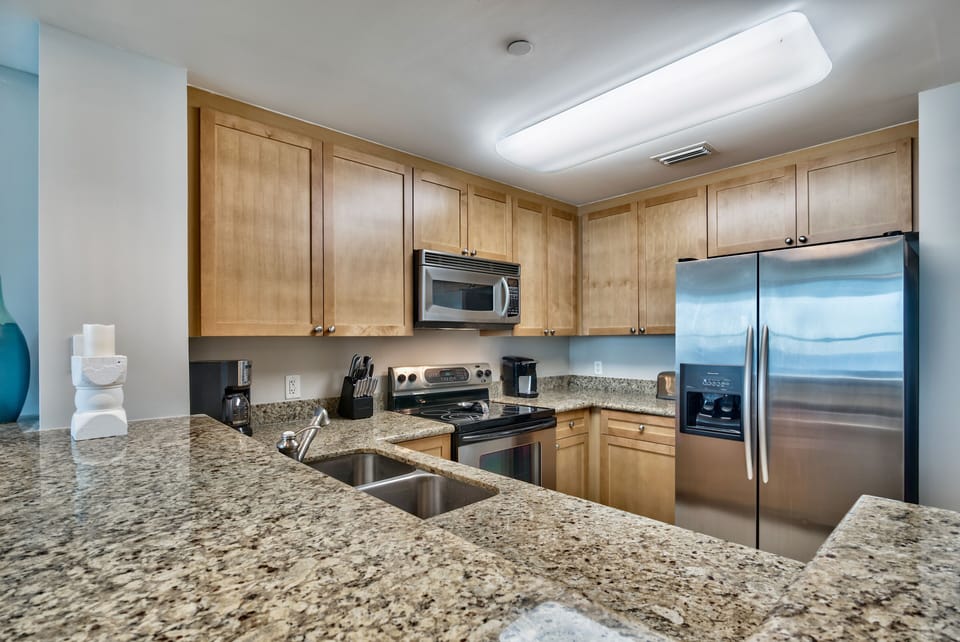 Kitchen is fully equipped with granite countertops, stainless steel appliances, drip coffee maker
