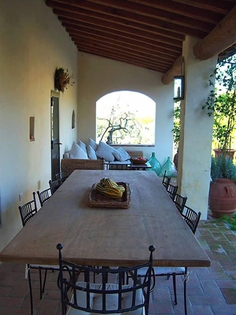 Outdoor dining and lounge areas leading onto a large stone courtyard