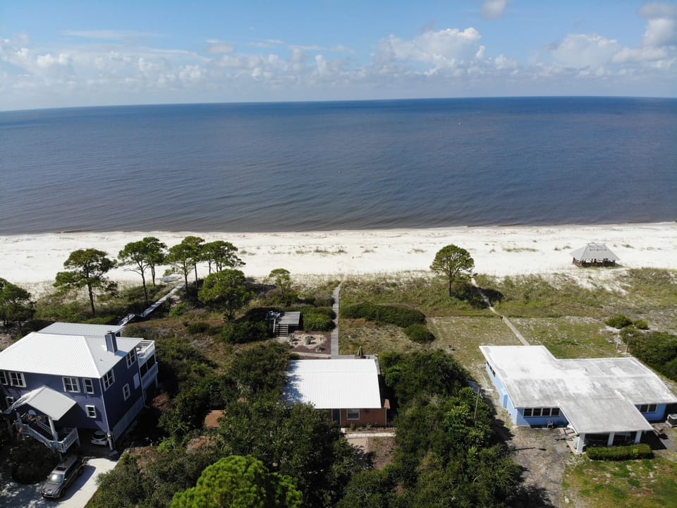 View of the house looking south. Boardwalk from the back door right to the beach