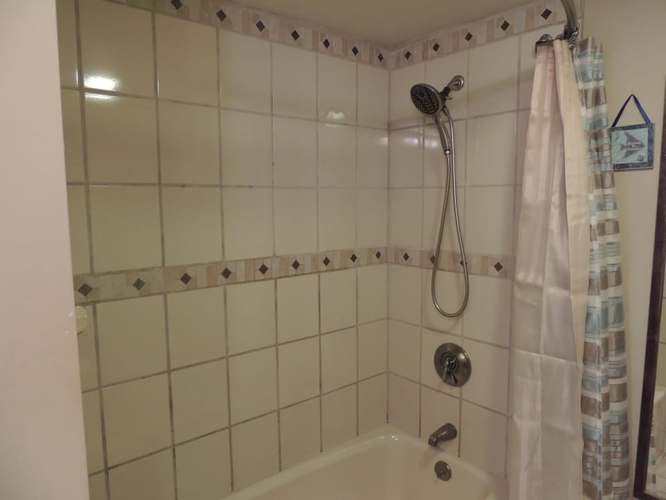 Tiled shower in full bath on main floor