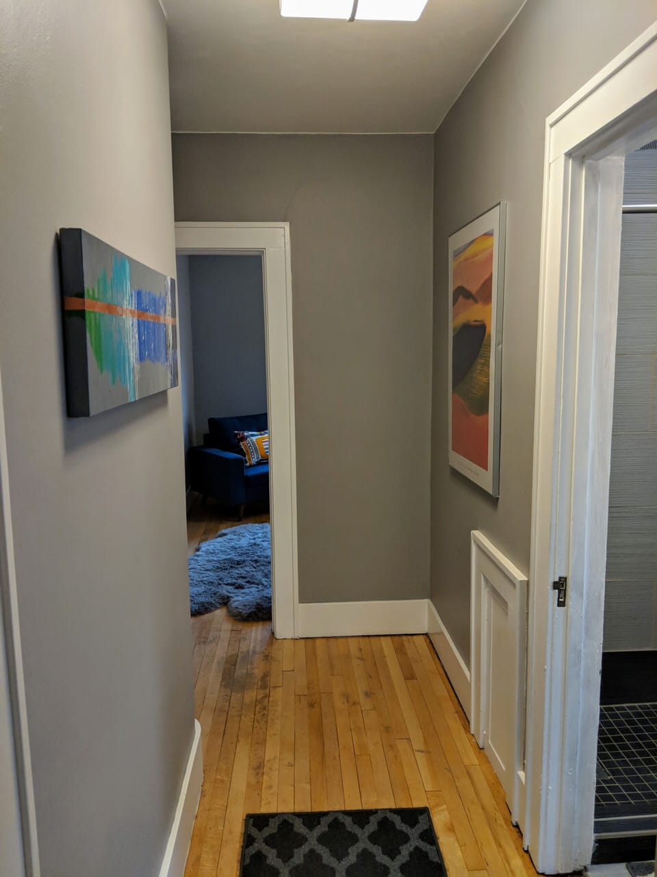 Modern and minimal decor with colorful art throughout.

