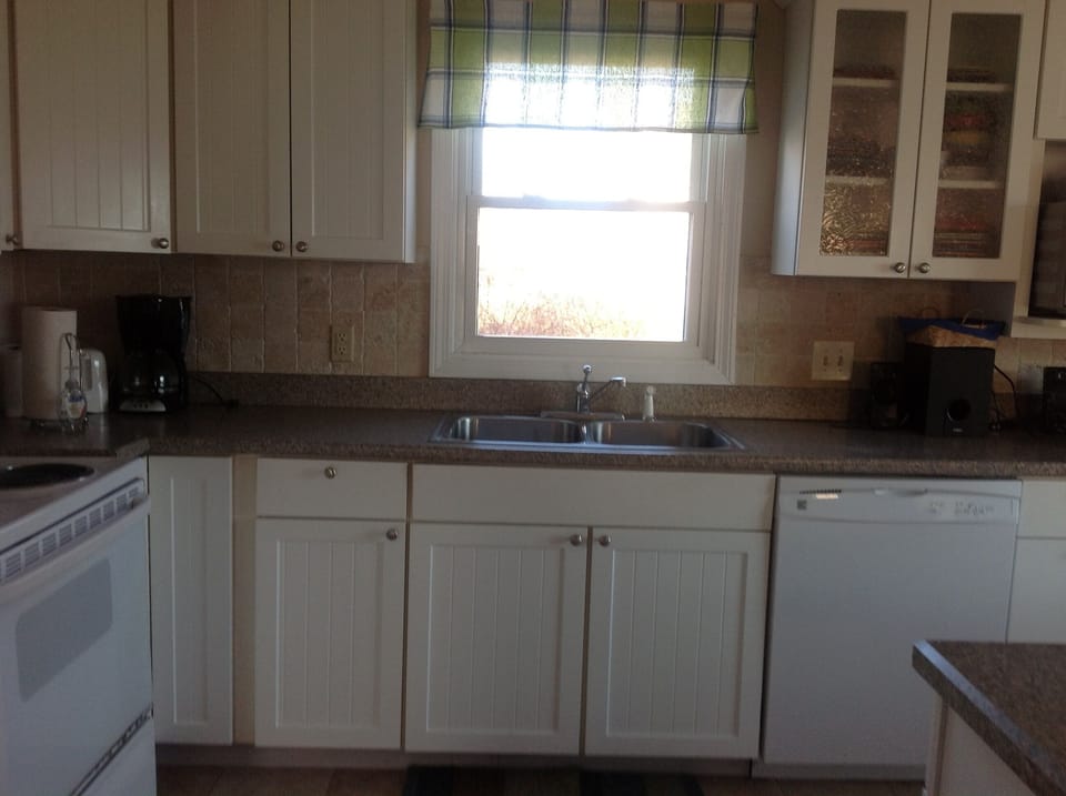 Kitchen with brand new dishwasher, refrigerator w ice maker, stove.