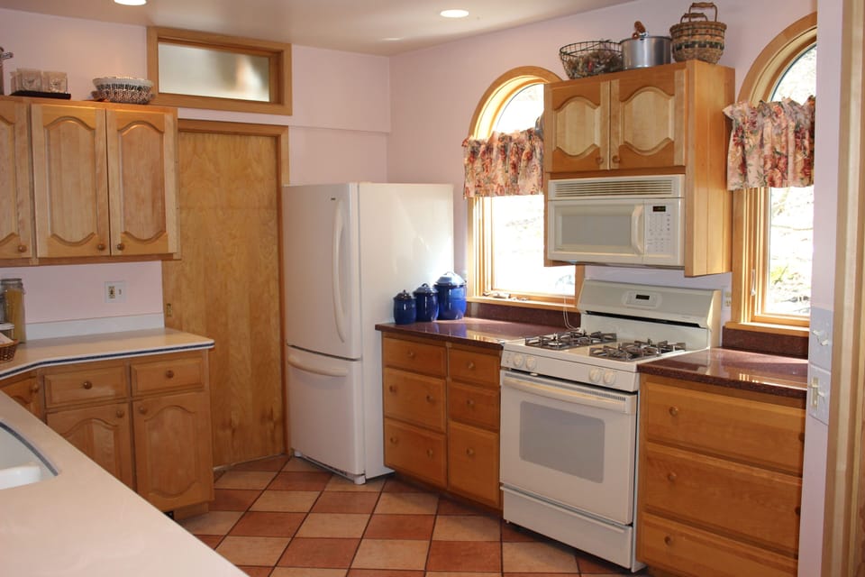 Sunny kitchen with granite countertops.