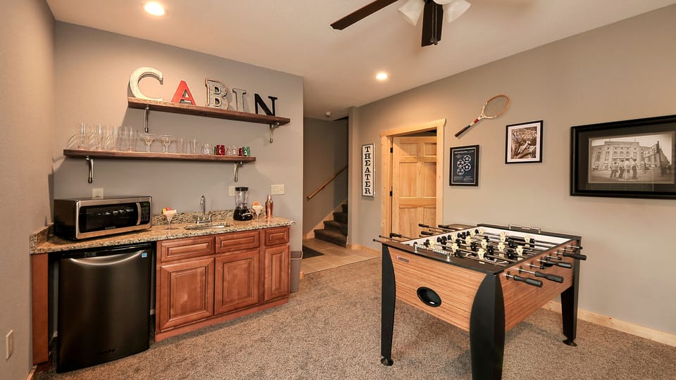 Basement game room w/wet bar, mini-fridge, microwave, and plastic drinkware