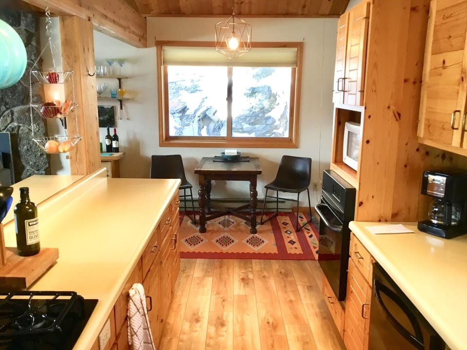 Pub table at end of kitchen expands for additional seating. 
