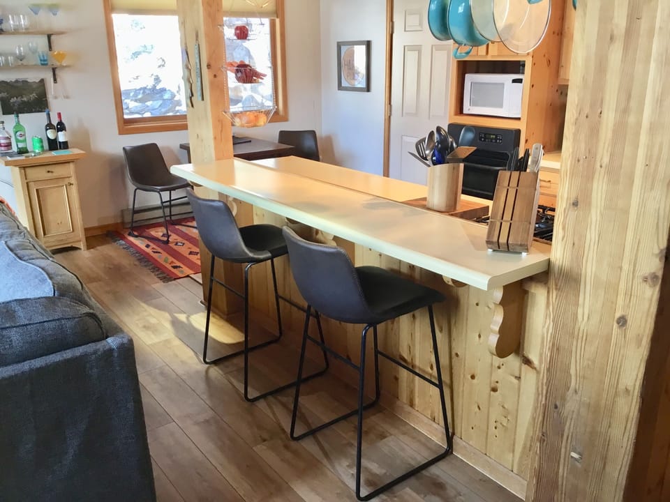 View of stylish open kitchen area with plenty of casual seating. 