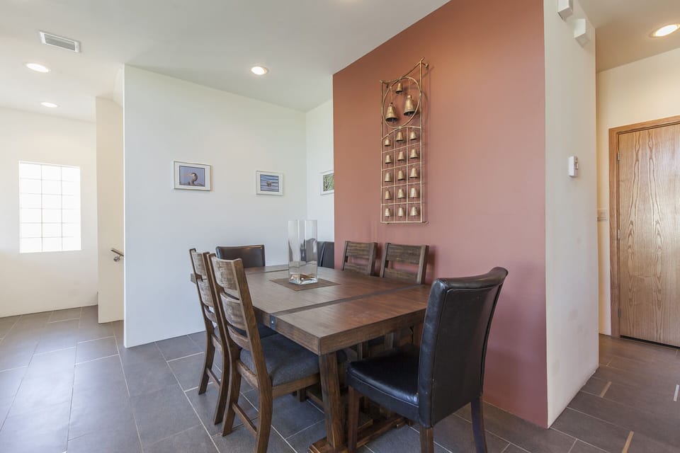 Gather around the dining table for family meals, game nights, or planning your island adventures.
