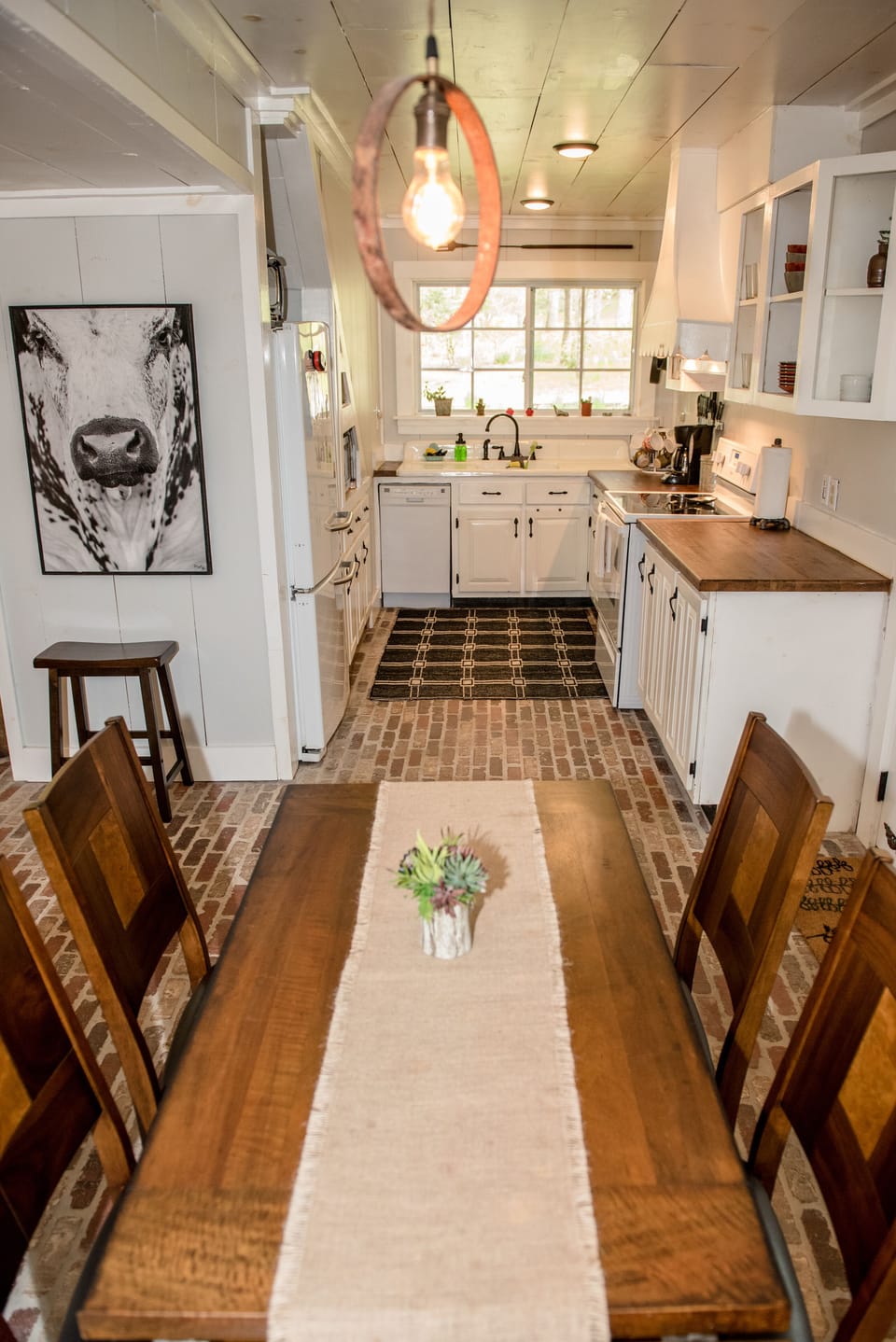 View from DR into kitchen (table has been updated with round seating for 6)